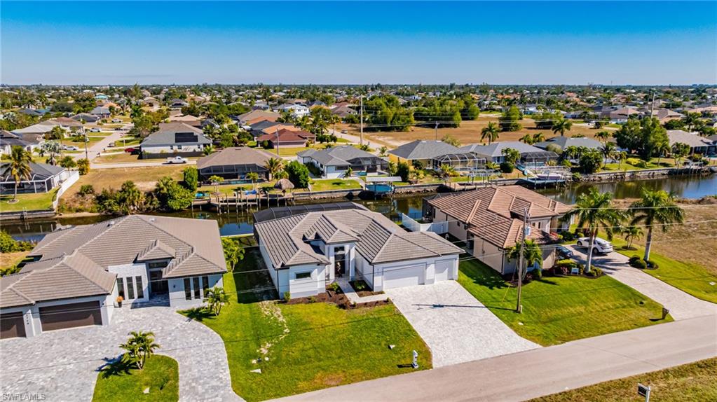 Aerial view of residential area featuring a large body of water