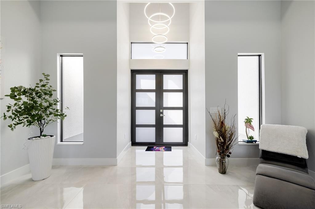 Entryway with a high ceiling and french doors
