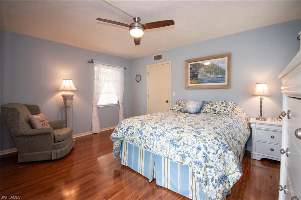Bedroom featuring dark wood-style flooring and ceiling fan