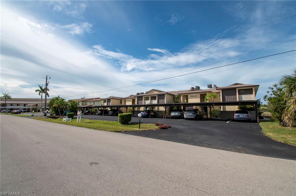 View of asphalt road featuring a residential view
