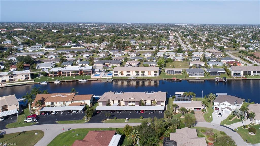 View of property location with a nearby body of water and nearby suburban area
