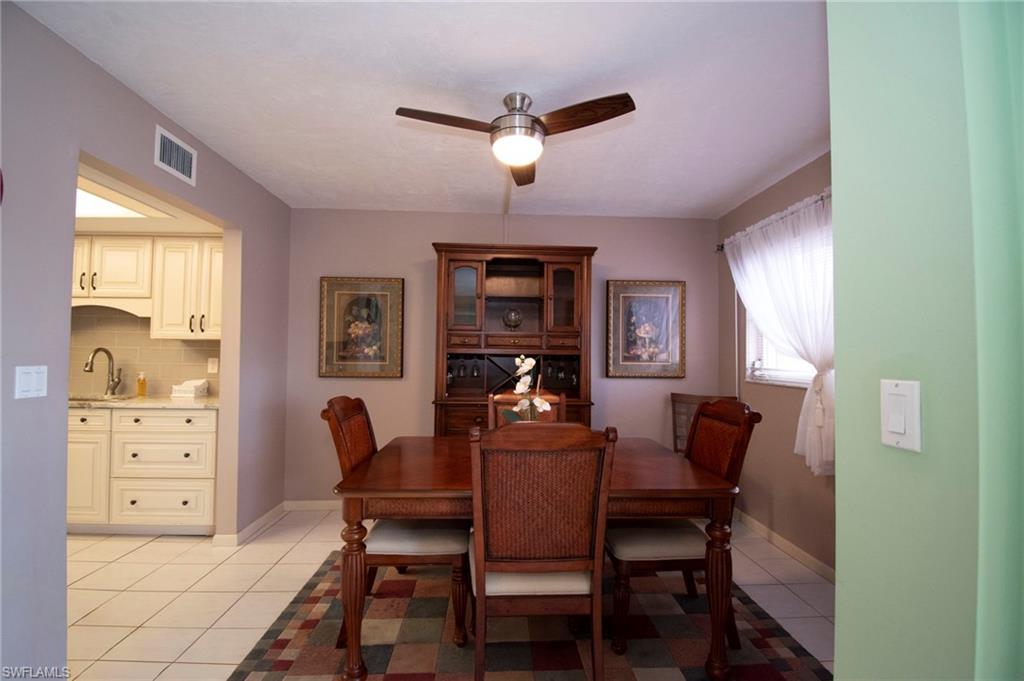 Dining area with light tile patterned flooring and ceiling fan