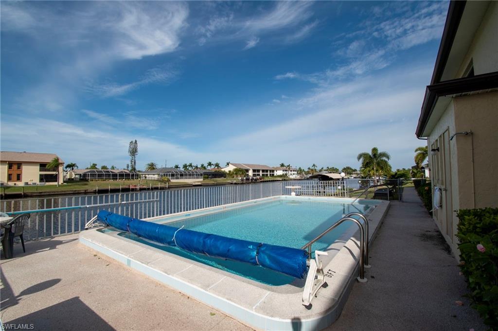 View of pool featuring a residential view and a water view