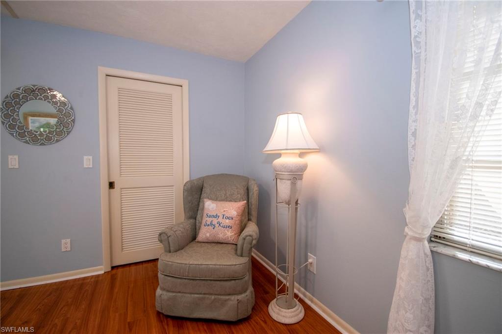 Living area with baseboards and wood finished floors