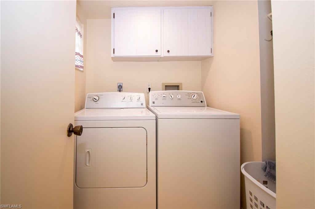 Laundry room with cabinet space and washer and clothes dryer