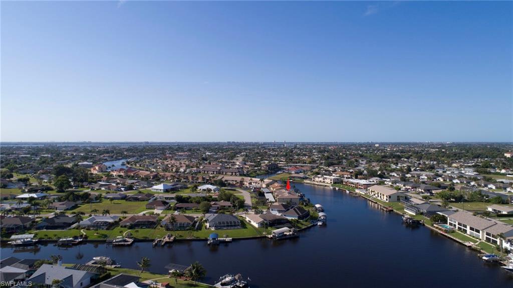 Aerial perspective of suburban area featuring a large body of water