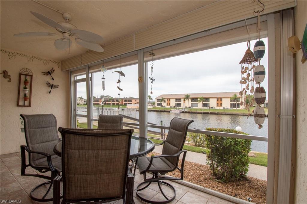 Sunroom / solarium featuring a water view and a residential view
