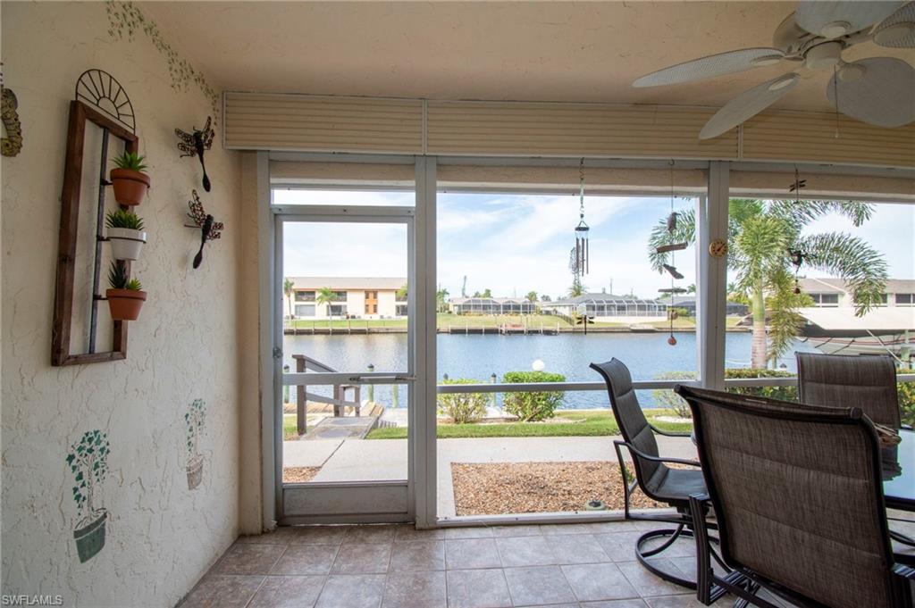 Sunroom featuring a water view and tile patterned floors