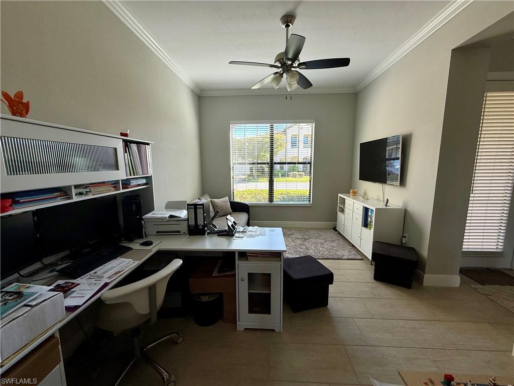 Office area with crown molding and a ceiling fan