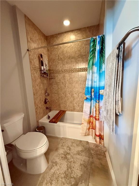 Bathroom featuring shower / bathtub combination with curtain and tile patterned floors