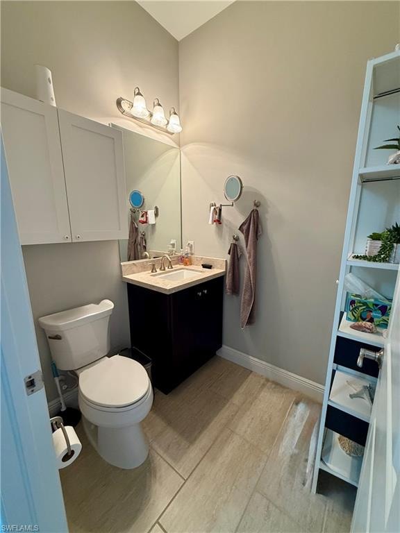 Half bath featuring vanity and toilet