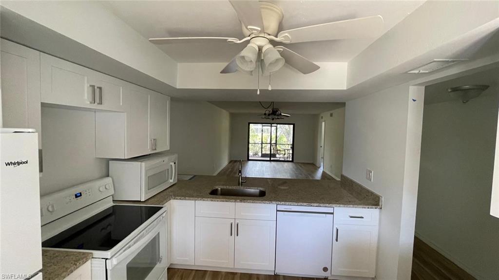 Kitchen featuring white appliances