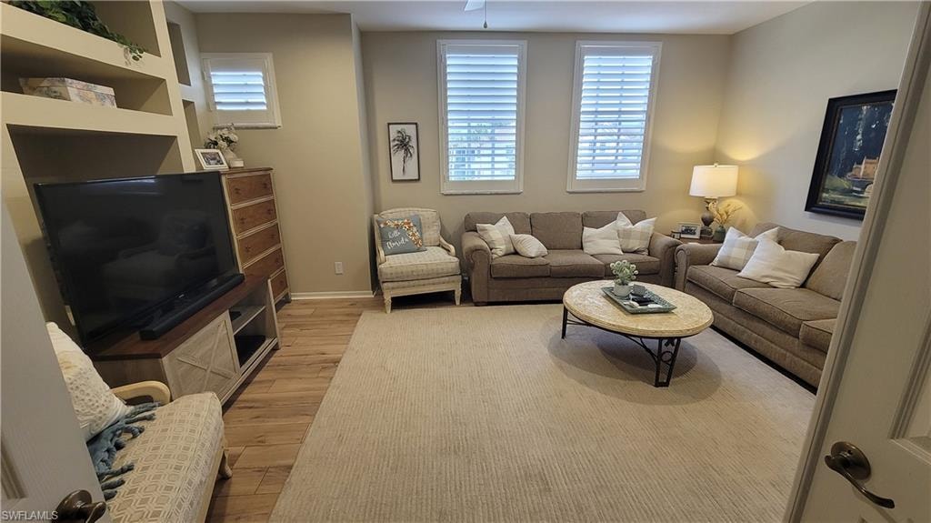 Living room with light wood finished floors and baseboards