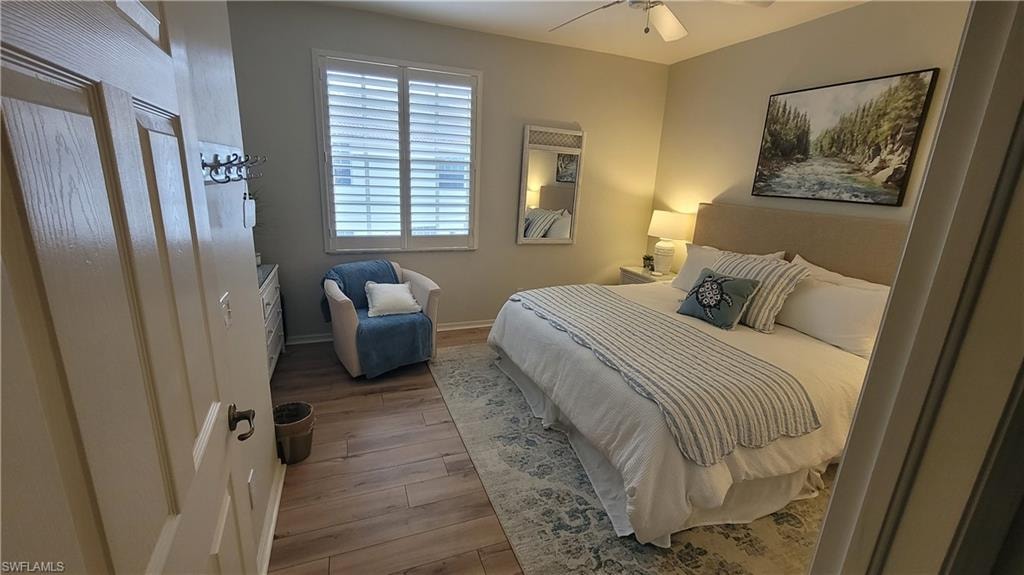 Bedroom with light wood-style flooring and a ceiling fan