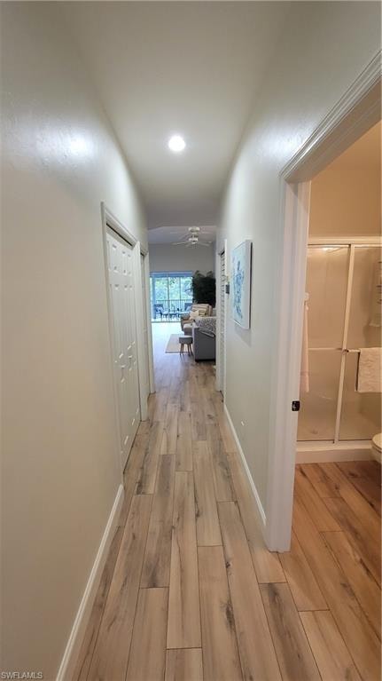 Corridor featuring light wood-style floors