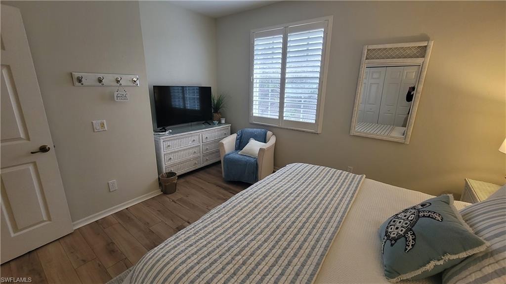 Bedroom featuring wood finished floors and baseboards