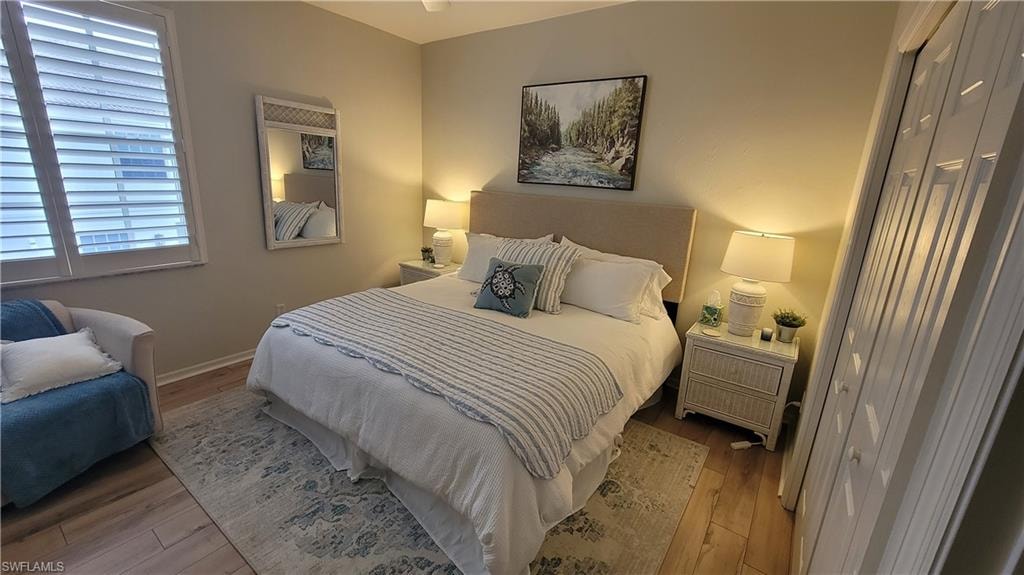 Bedroom with wood-type flooring and baseboards