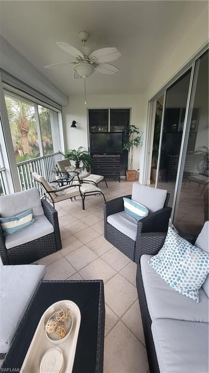 Sunroom featuring an outdoor lounge area and a ceiling fan