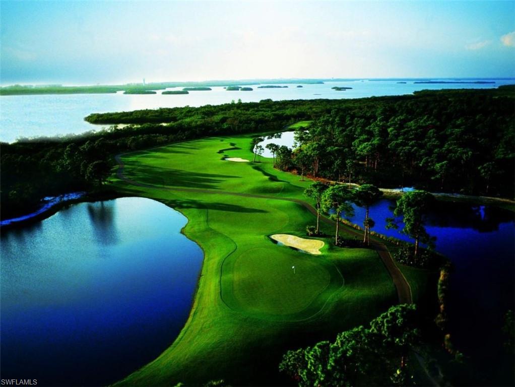 Aerial view of property and surrounding area with a large body of water and a golf course