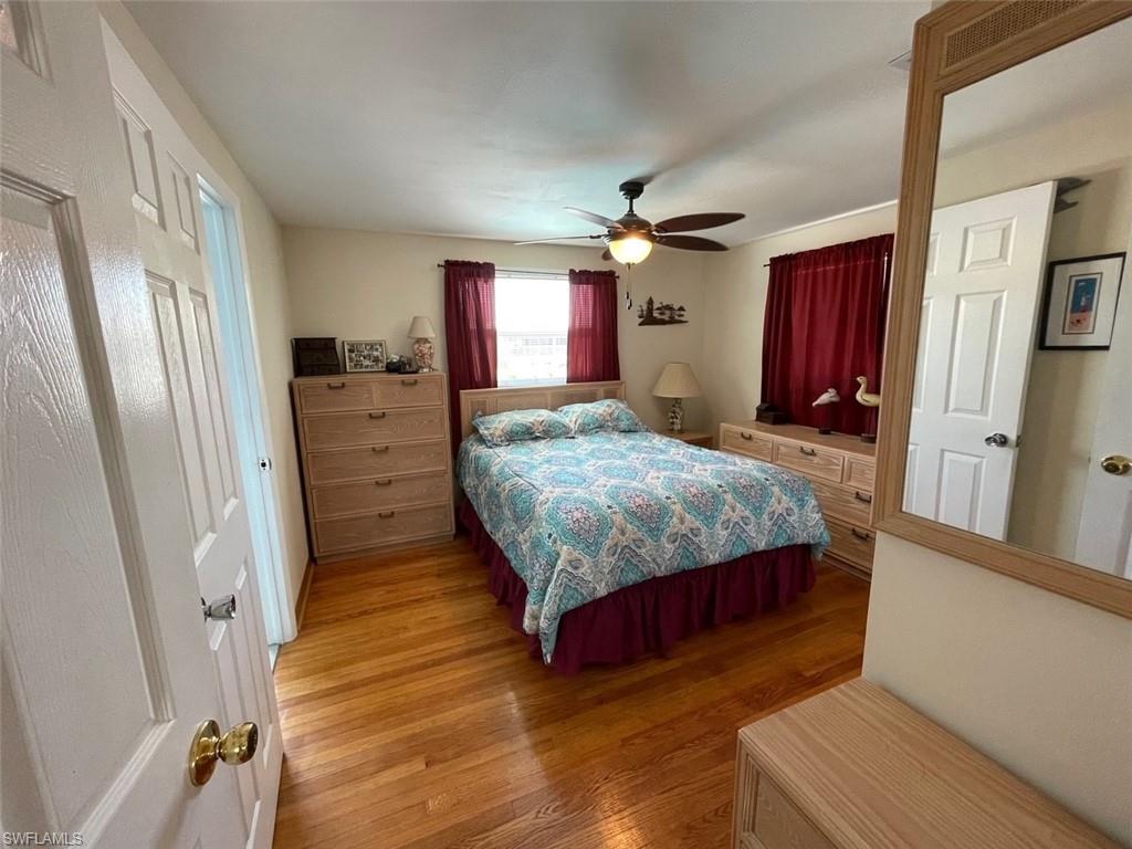 Bedroom featuring a ceiling fan and oak wood finished floors