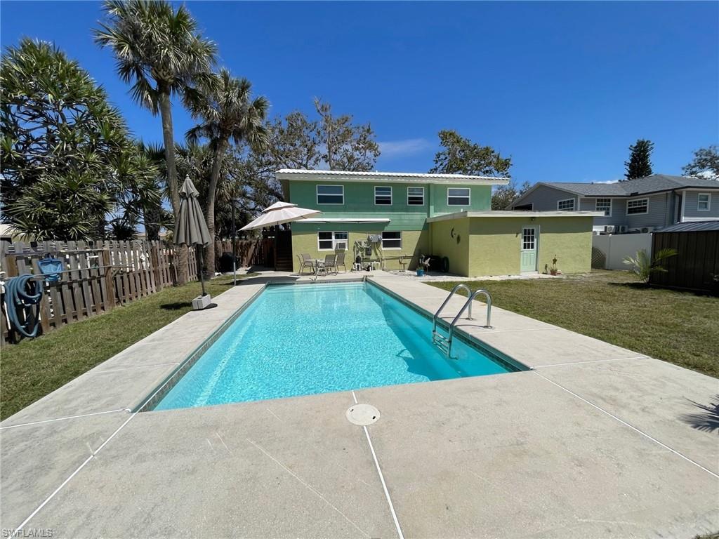 View of pool featuring a fenced in pool, a lawn, a fenced backyard, and a patio area