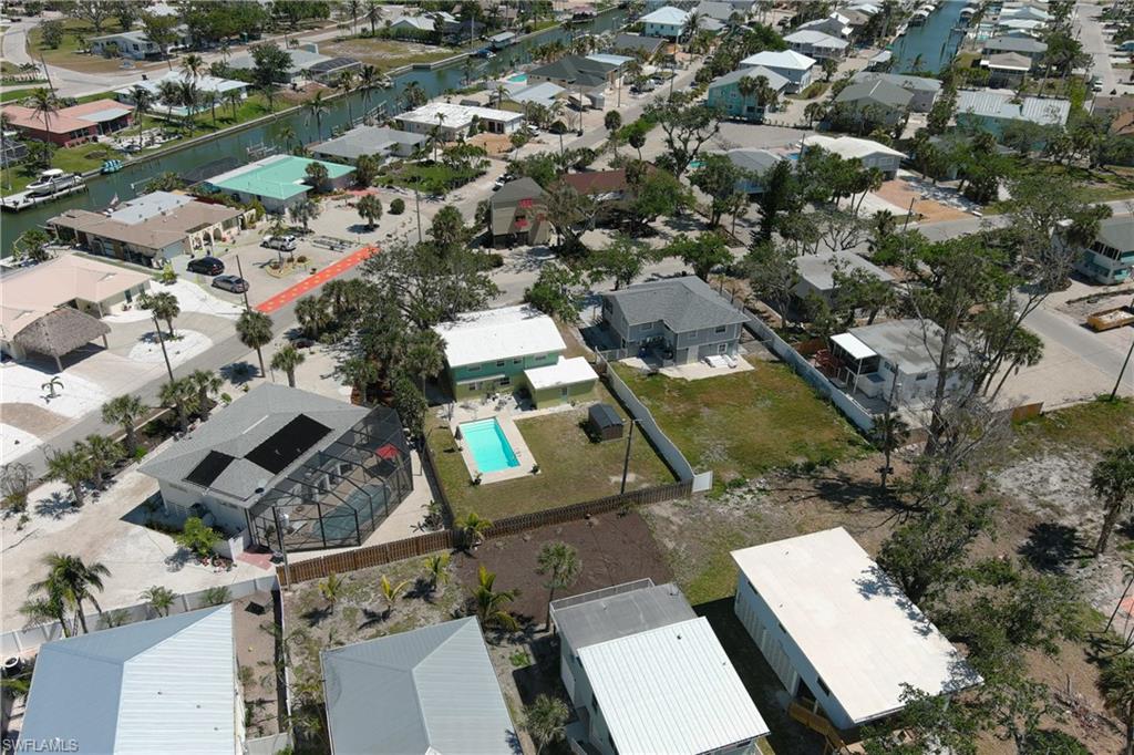 Drone / aerial view with a water view and a residential view