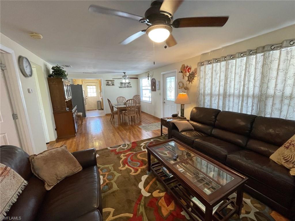 Living area with real oak wood flooring , new windows and ceiling fan