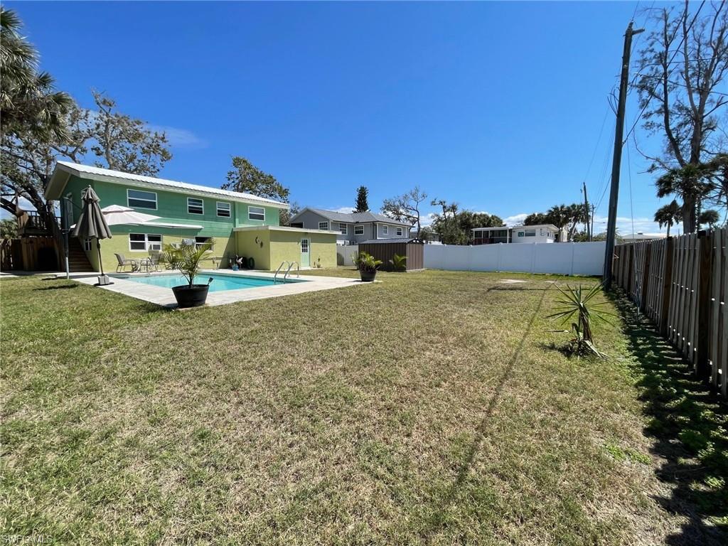 View of yard with a fenced in pool, a fenced backyard, and a patio area