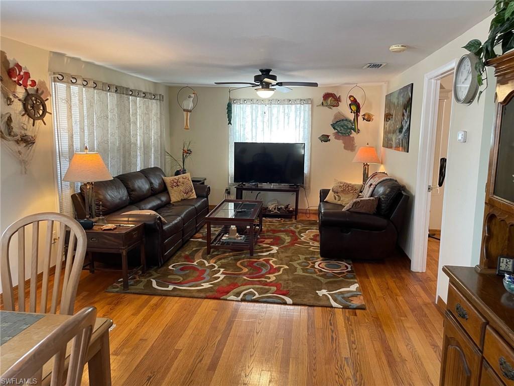 Living area featuring real oak wood  floors and ceiling fan