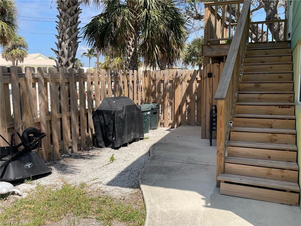 View of storage area ,new stairway, small patio, and new fence
