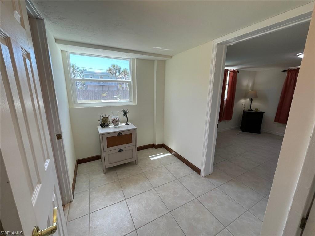 Bedroom featuring light tile patterned floors and baseboards