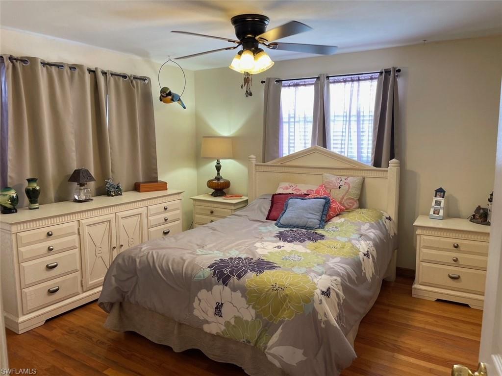 Bedroom featuring a ceiling fan and oak wood finished floors