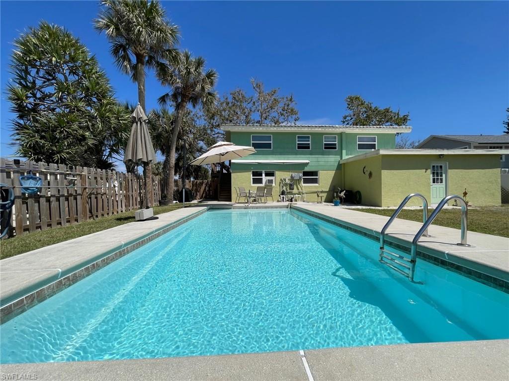 View of swimming pool with a fenced in pool, a patio area, and fence