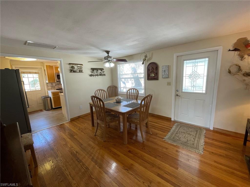 Large Dining area featuring real oak flooring, , new windows and a ceiling fan