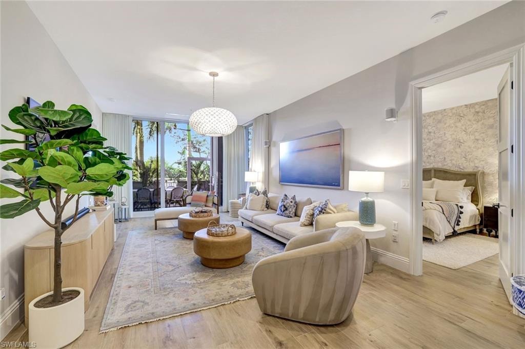 Living room with expansive windows and light wood finished floors