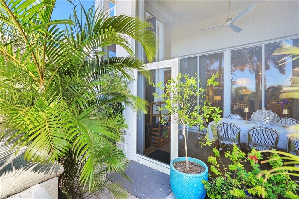 Furnished lanai featuring plenty of natural light and lush landscaping
