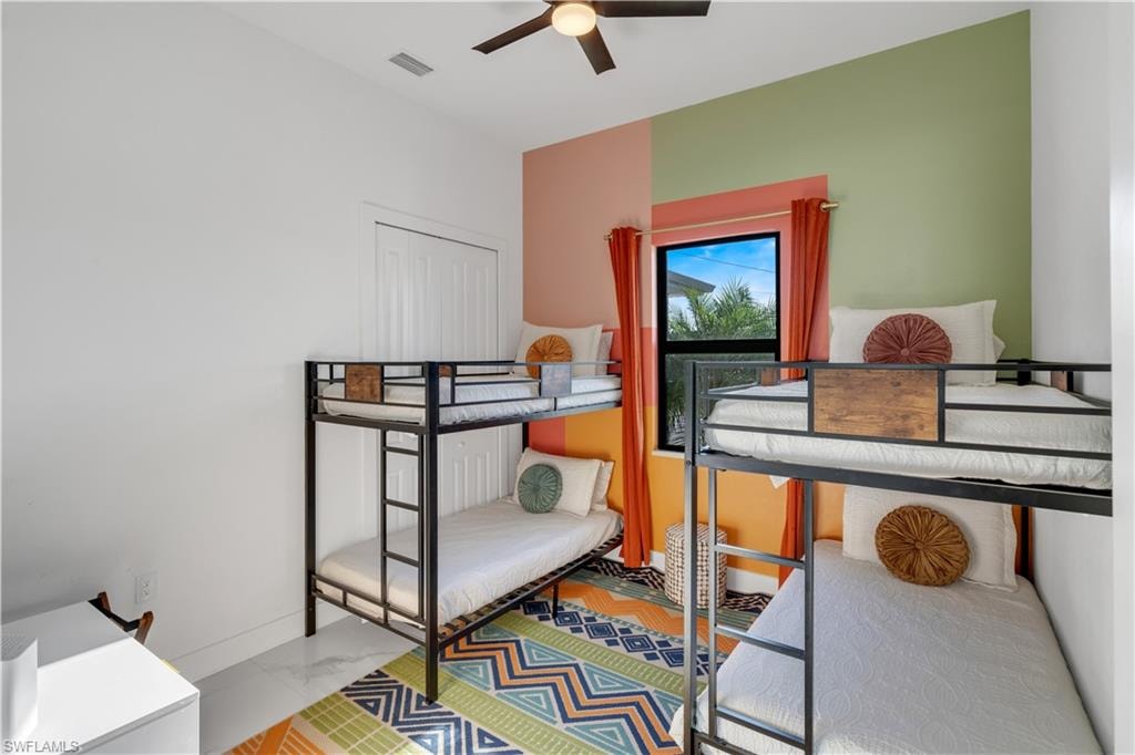 Bedroom with a ceiling fan and baseboards