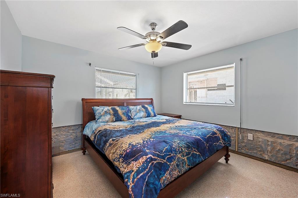 Bedroom featuring multiple windows and ceiling fan