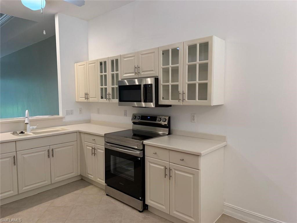 Newly renovated kitchen with new appliances and new glass cabinet doors