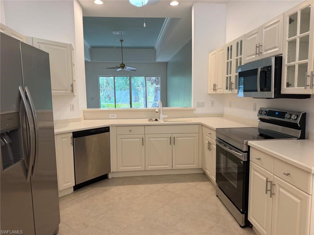Newly renovated kitchen with new stainless appliances and glass cabinet doors