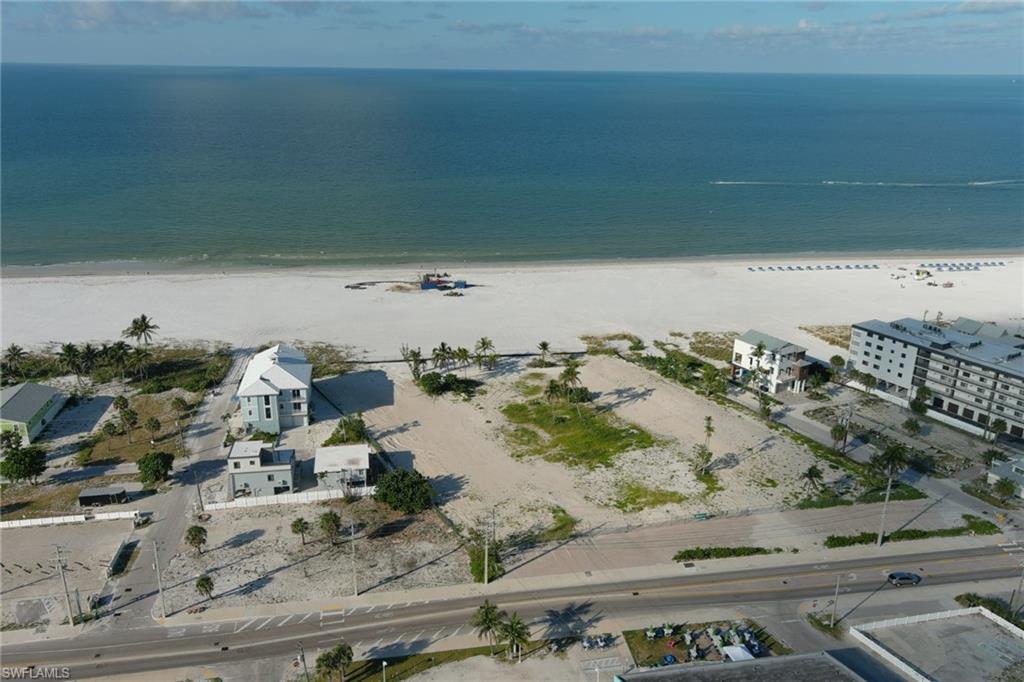 Aerial view of property and surrounding area with extended coastline