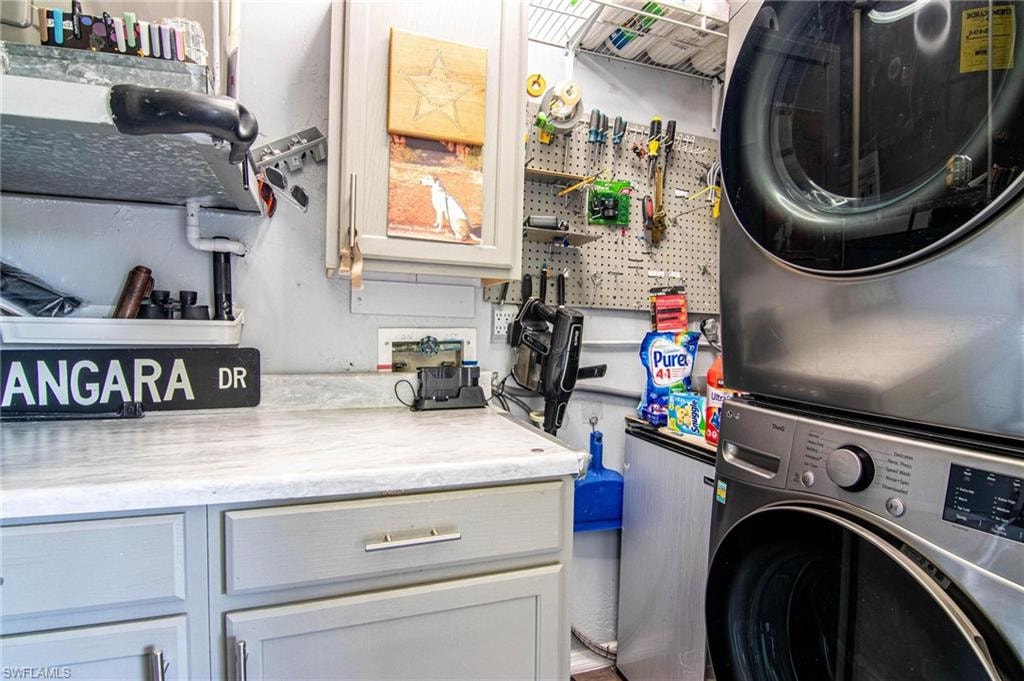 Laundry room featuring stacked washer / drying machine