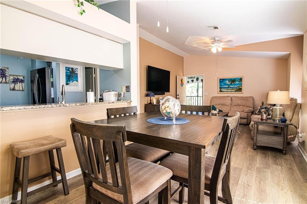 Dining room featuring light hardwood / wood-style floors, ceiling fan, and sink