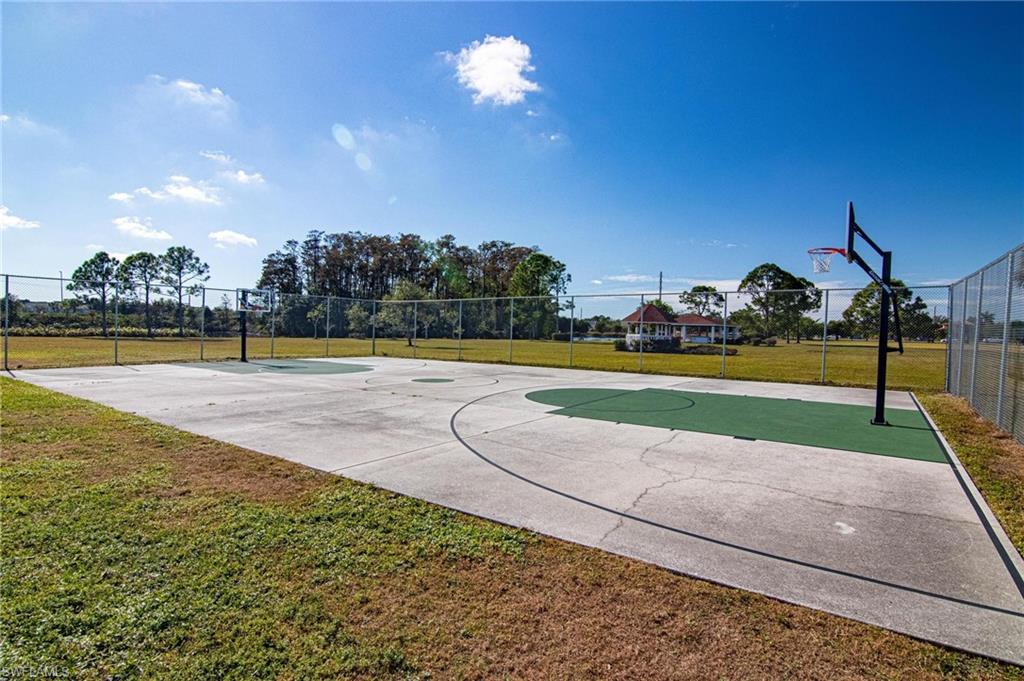 View of basketball court with a lawn