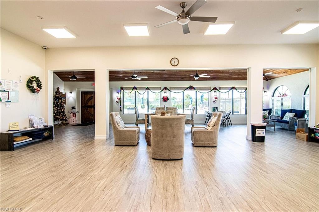 Living room with plenty of natural light and hardwood / wood-style flooring