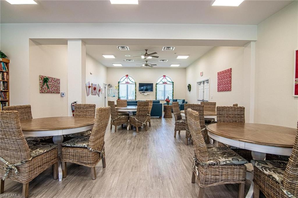 Dining space with ceiling fan and light wood-type flooring