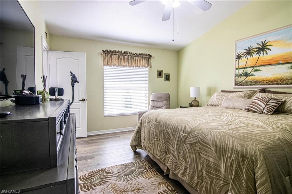 Bedroom featuring ceiling fan, light hardwood / wood-style flooring, and vaulted ceiling