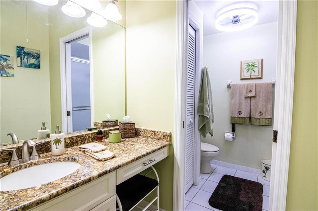 Bathroom featuring tile patterned floors, vanity, and toilet