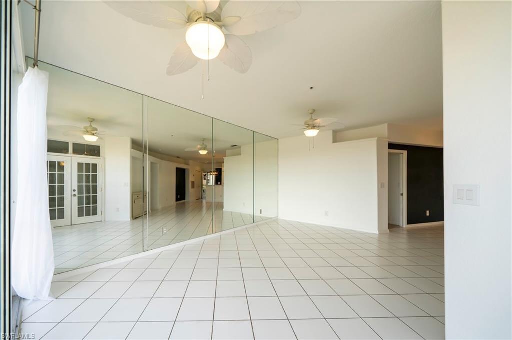 Unfurnished room featuring light tile patterned floors and french doors
