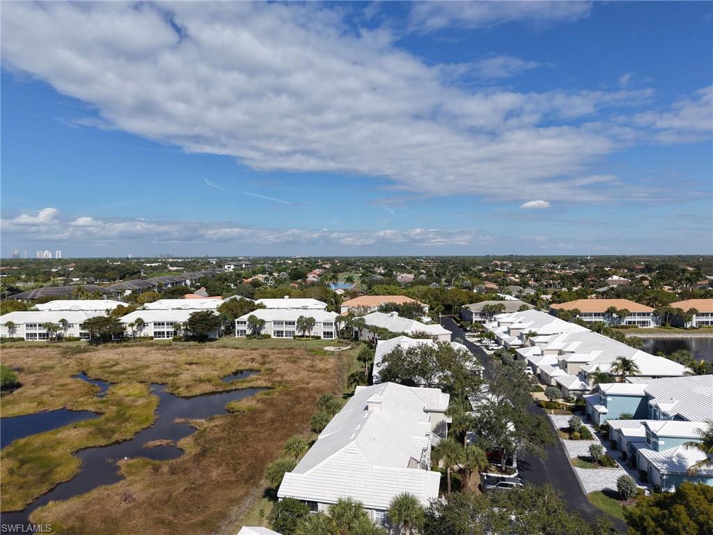 Aerial view of property's location with a large body of water and nearby suburban area